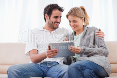 Happy couple using a tablet computer