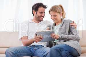 Happy couple using a tablet computer