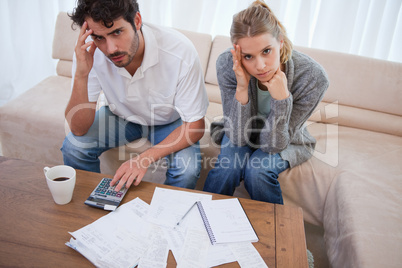 Worried couple doing their accounting