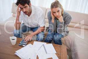 Worried couple doing their accounting