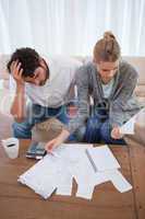 Portrait of a depressed couple doing their accounting