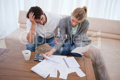 Depressed couple doing their accounting