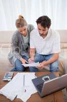 Portrait of a couple doing their accounting with a notebook