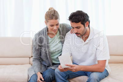 Couple opening an envelope