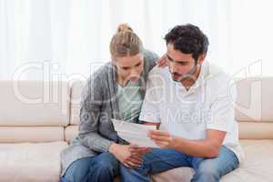 Focused couple reading a letter