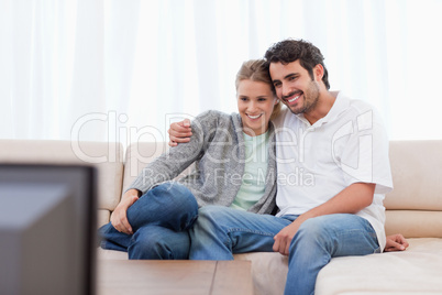 Happy couple watching TV Happy couple watching TV