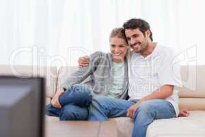 Happy couple watching TV