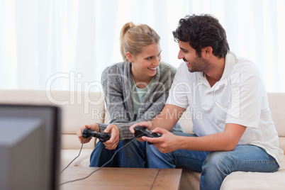 Happy couple playing video games