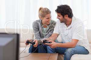 Happy couple playing video games