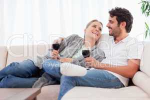 Young couple having a glass of red wine