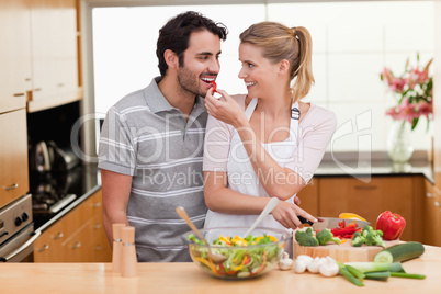 Lovely couple slicing pepper