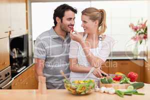 Lovely couple slicing pepper