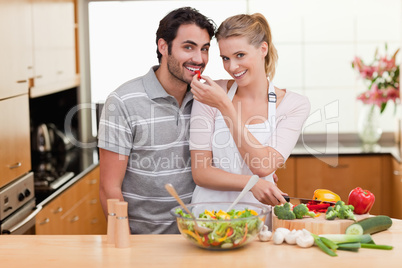 Young couple slicing pepper