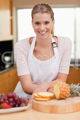 Portrait of a woman posing with a sliced pineapple