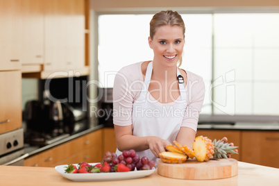 Woman posing with a sliced pineapple