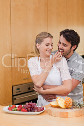 Portrait of a young couple eating fruits