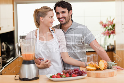 Couple making fruits juice