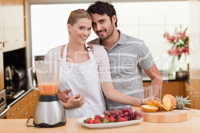 Couple making fresh fruits juice