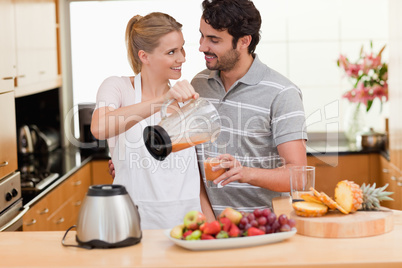 Young couple making fresh fruits juice