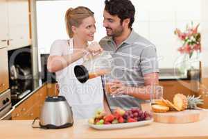Young couple making fresh fruits juice