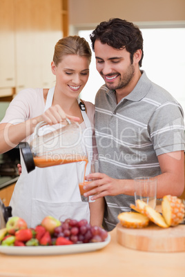 Portrait of a young couple drinking fruits juice