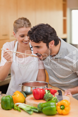 Portrait of a young couple preparing a sauce
