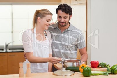 Lovely couple preparing a sauce