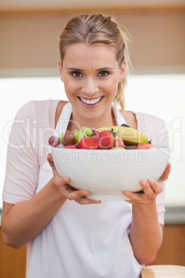Portrait of a woman holding a fruit basket