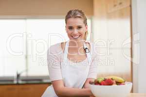 Woman posing with a fruit basket