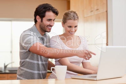 Couple using a notebook while having coffee