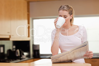 Woman reading the news while having coffee