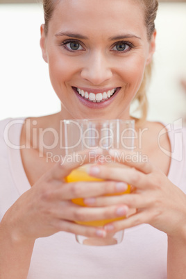 Portrait of a smiling woman drinking juice