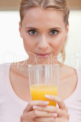 Portrait of a young woman drinking juice