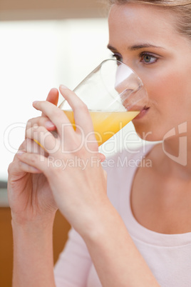 Portrait of a quiet woman drinking juice