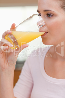 Portrait of a calm woman drinking juice