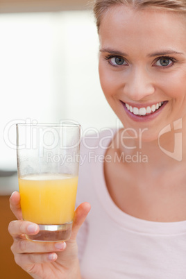 Portrait of a young woman drinking orange juice