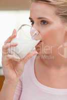 Portrait of a woman drinking a glass of milk