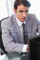 Portrait of a serious businessman working with a computer