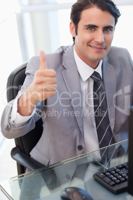 Portrait of a businessman working with a computer with the thumb