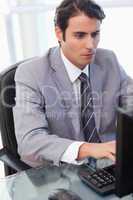 Portrait of a focused businessman working with a computer