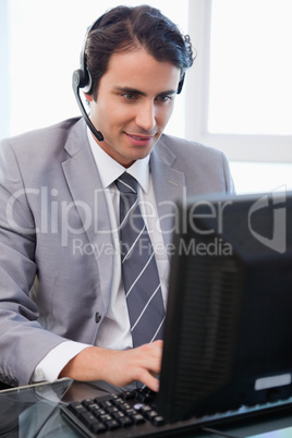 Portrait of a happy sales assistant working with a monitor