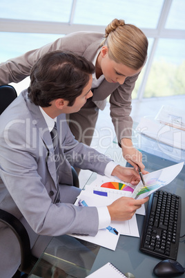 Portrait of a manager pointing at something to her employee on a