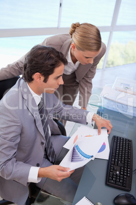 Portrait of a manager and his secretary looking at a graph