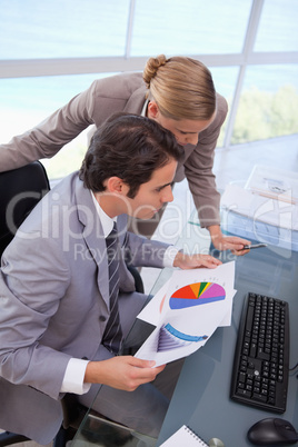 Portrait of a business team looking at a graph
