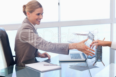 Smiling businesswoman receiving a customer