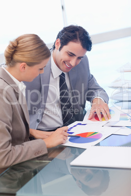 Portrait of smiling business people studying statistics