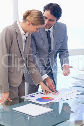 Portrait of smiling business people looking at statistics