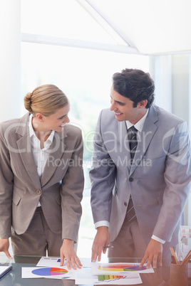 Portrait of happy business people looking at statistics