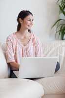 Portrait of a smiling woman using a notebook