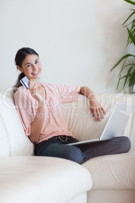 Portrait of a delighted woman shopping online